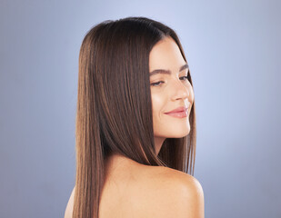 Fototapeta premium Woman, beauty and hair care smile in studio for texture, growth and healthy shine on blue background. Aesthetic female model face for haircare, self love and cosmetics for salon or hairdresser mockup