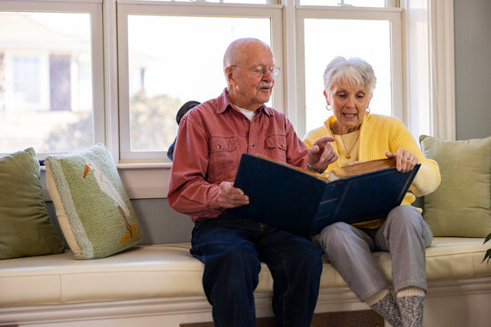 Senior Citizen couple Looking at photo album 
