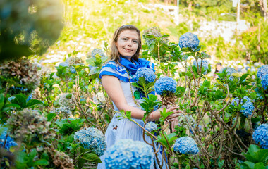 Portrait of beautiful woman in national folk costume in a field of flowers. Nicaraguan national...