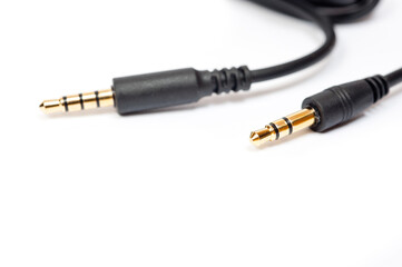 Black cord with a mini jack for connecting various gadgets, shot on a white background.