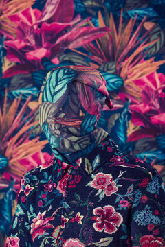 blending in with the floral wallpapered background