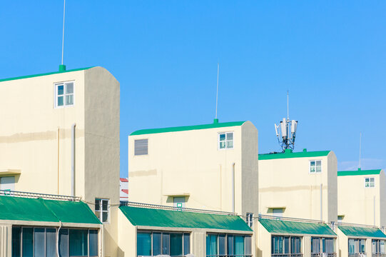 Green And Yellow Apartment Building Rooftop Structure.