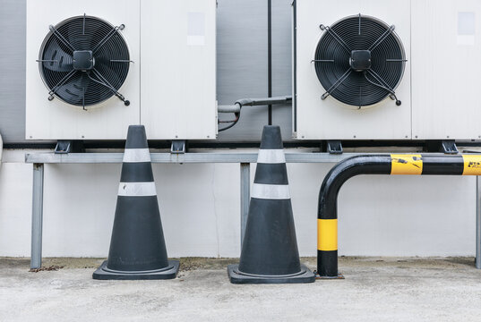 Ventilation fans and guards installed next to the building.