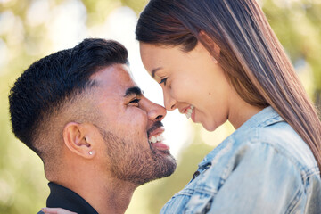 Face, smile and a couple in the garden together, feeling happy while dating for romance in summer. Love, park or spring with a man and woman bonding outside in nature as a romantic partnership