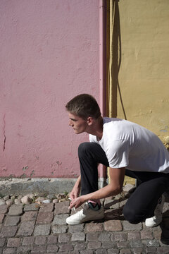 Young man tying his shoelaces