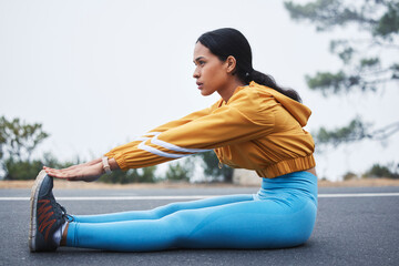 Sports, leg stretching and woman runner doing exercise on a outdoor road feeling serious. Workout,...