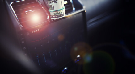 Concept background. dollars with a car key lie in inside cars. financial concept