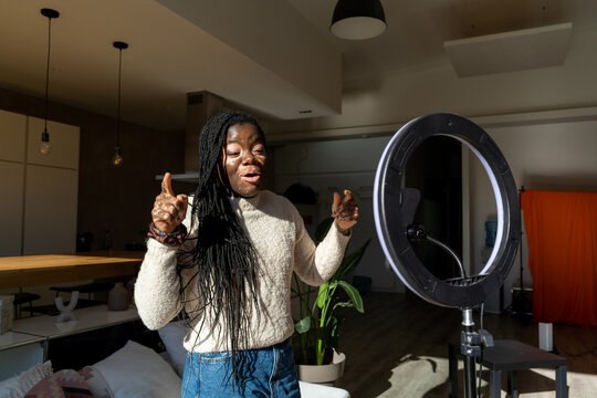 woman recording video blog at home