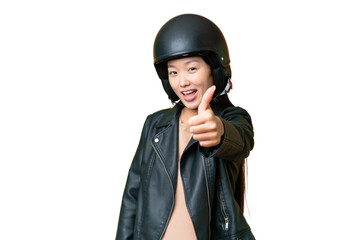 Young Asian woman with a motorcycle helmet over isolated chroma key background with thumbs up because something good has happened