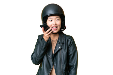 Young Asian woman with a motorcycle helmet over isolated chroma key background keeping a conversation with the mobile phone