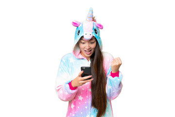 Young Asian woman with unicorn pajamas over isolated chroma key background surprised and sending a...