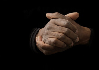 Obraz premium man praying to god with hands together Caribbean man praying with black background stock photos stock photo