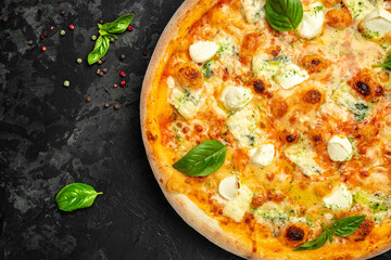 four cheese pizza, on a dark background, Fast food lunch, top view. place for text