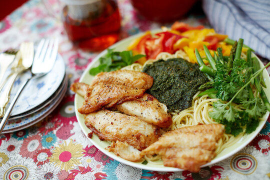 Homemade food, pasta with cod and vegetables pesto