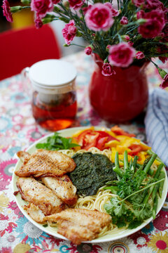 Homemade food, pasta with cod and vegetables pesto