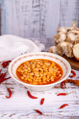 Dry bean meal. Dry bean dish in plate on white wooden background. Local name kuru fasulye