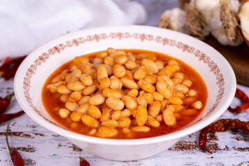 Dry bean meal. Dry bean dish in plate on white wooden background. Local name kuru fasulye. Close up