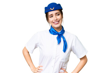 Airplane stewardess over isolated chroma key background posing with arms at hip and smiling