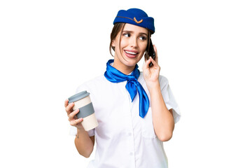 Airplane stewardess over isolated chroma key background holding coffee to take away and a mobile
