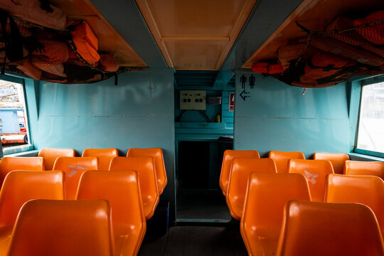 Bright orange passenger seats on a tourist boat in Thailand