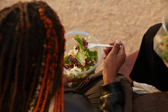 View of woman eating pre made salad