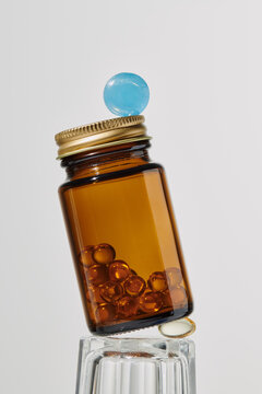 Jar of vitamins, a glass and pills