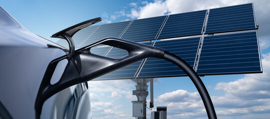 Naklejka premium Close up of electric car with a connected charging cable on the background of solar panels