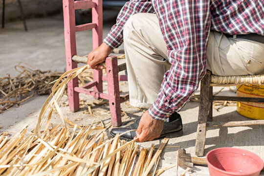Anonymous Artisan Selects Reed Leaves To Weave A Seat