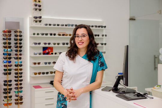 Smiling optometrist in store with eyeglasses