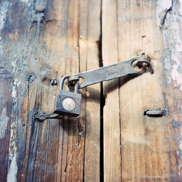 Padlock on wooden door