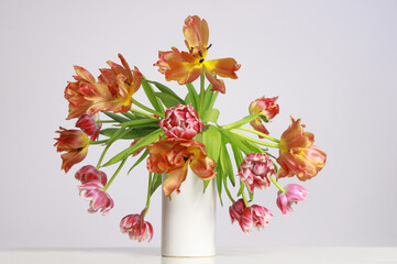 vase with wilted tulips