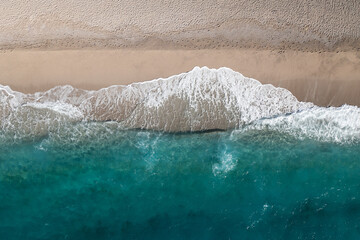 Fototapeta na wymiar Deserted beach and beautiful sea wave in a shape of rocky mountain