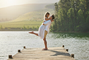 Couple, lake hug and engagement announcement of young people in love in nature. Happy, relax and...