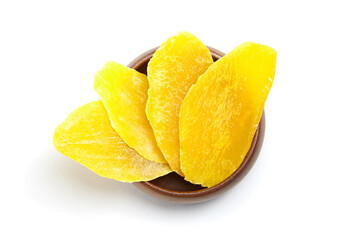 Dried mango slices in wooden bowl isolated on white background, top view. Candied mango fruits