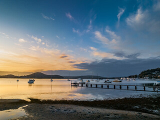 Aerial sunrise waterscape with boats and high cloud