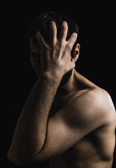 Fototapeta premium portrait of young boy with naked body covering his face. studio photography