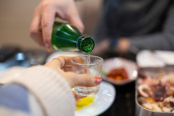 Cheers with soju. Korean popular alcholic drink