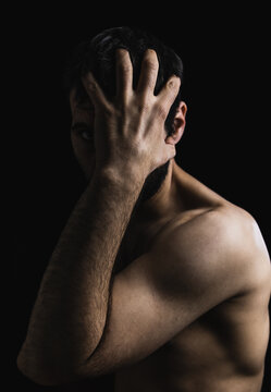 Portrait Of Young Boy With Naked Body Covering His Face. Studio Photography