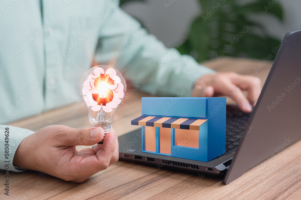 Aufkleber Man holding a light bulb while working on a computer to think and generate new ideas for business ideas about online store expansion, sales and purchases in online shop internet shopping.