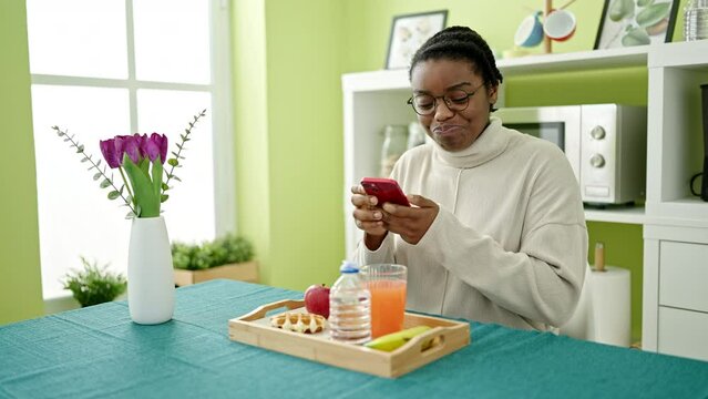 African american woman taking picture to breakfast at dinning room