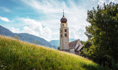 Amazing nature landscape in the Italian Alps. Wonderful summer view of San Valentino Church on...