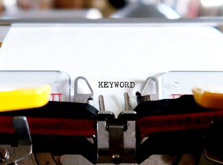 An old typewriter with a typing text KEYWORD, means words people type into internet search engines to find information contains with 