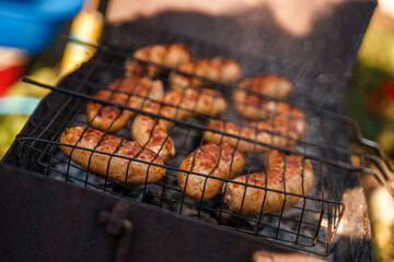 Sausages are grilled on a grill, frying in the fresh air. Street food.