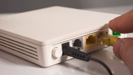 Internet cable in the hand inserting in the socket router
