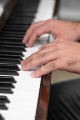 Fototapeta na wymiar hands of a man playing piano .