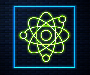 Glowing neon line Atom icon isolated on brick wall background. Symbol of science, education, nuclear physics, scientific research. Vector