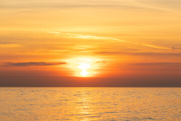 Naklejka na ściany i meble sunset on the sea, seascape, the sun sets behind the clouds