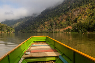 Naklejka premium Boat travelling on Nam Ou river, Laos