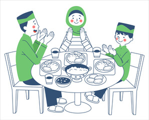 A Muslim family is praying before eating together at the dining table