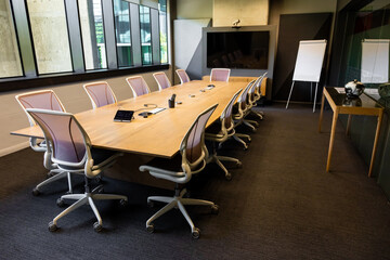 Empty boardroom table and chairs